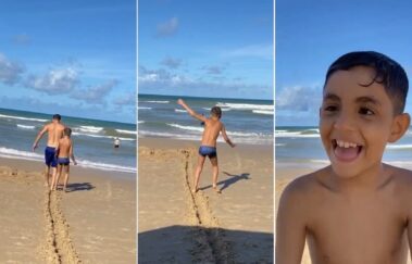 Pai traça caminho na areia para filho deficiente visual aproveitar praia